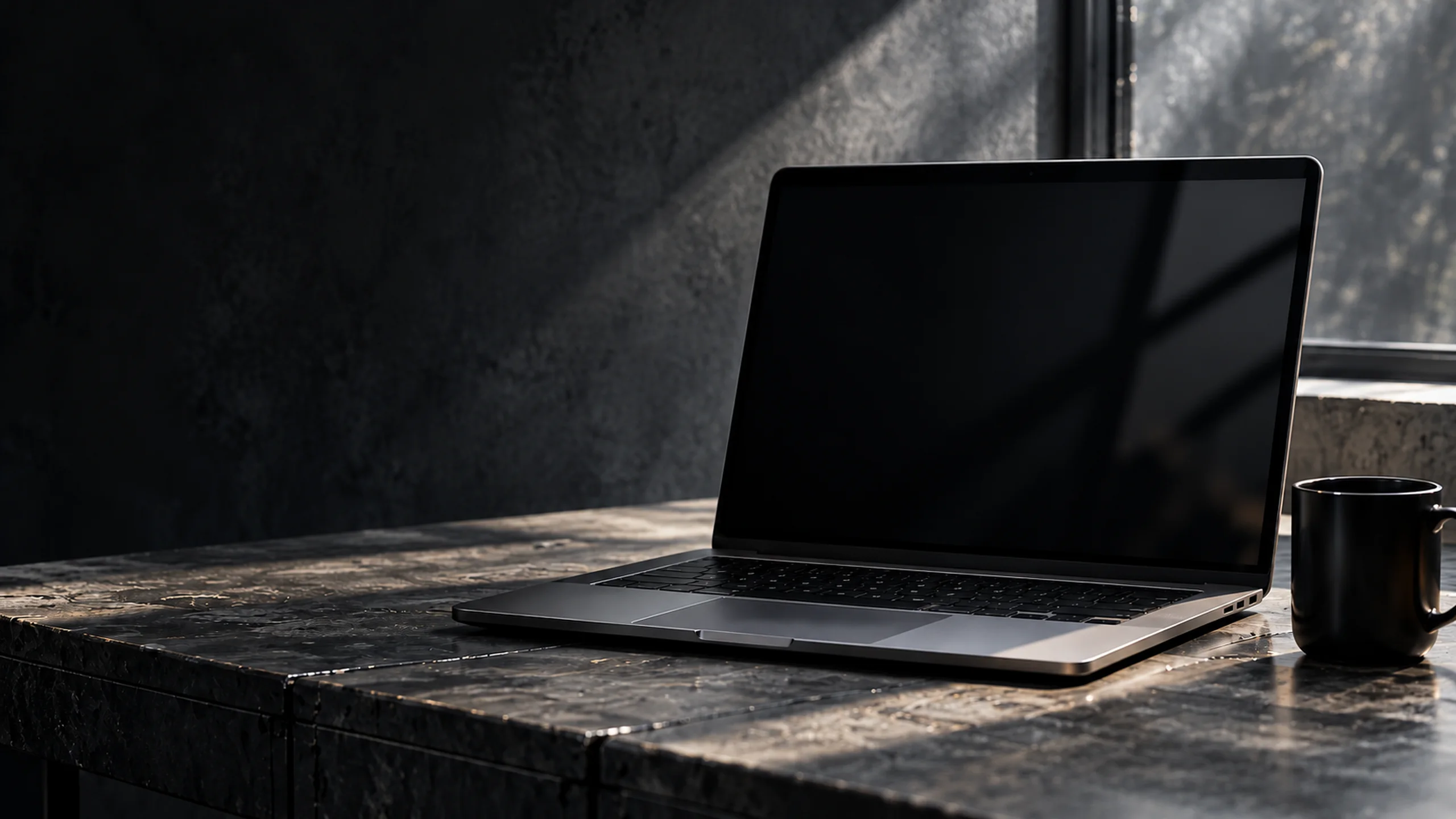 Illustration: a dark stone desk with a laptop and a mug